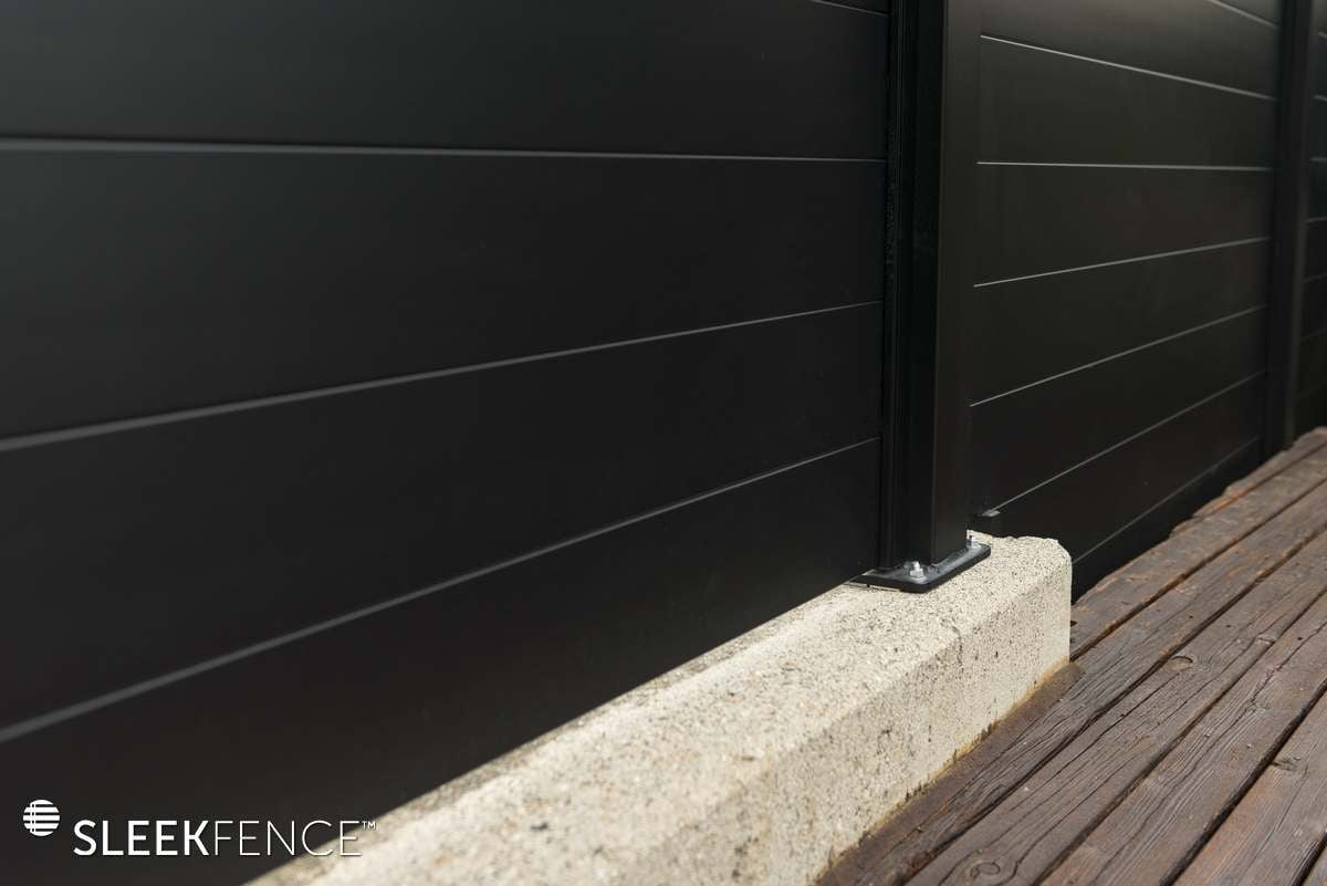 sleek privacy fence on concrete wall